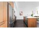 A modern kitchen featuring stainless steel appliances and a convenient island, with dark wood flooring at 2880 Zuni St # 309, Denver, CO 80211