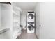Efficient laundry room with stacked washer and dryer, offering ample storage space at 2880 Zuni St # 309, Denver, CO 80211
