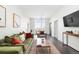 An open-concept living room featuring a plush sofa, a stylish area rug, and modern decor at 2880 Zuni St # 309, Denver, CO 80211