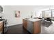 An open-concept living room featuring a modern kitchen with island, comfortable seating and elegant decor at 2880 Zuni St # 309, Denver, CO 80211