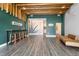 Modern lobby featuring green walls, wood floors, a mural, and seating area at 2880 Zuni St # 309, Denver, CO 80211