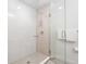 Contemporary shower with glass door, rainfall showerhead, and light tile walls and flooring at 2880 Zuni St # 309, Denver, CO 80211