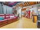 Partially finished basement with exposed ceiling, laminate flooring, and cozy seating area at 6284 Orion Ct # B, Arvada, CO 80403