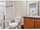 Bathroom with tiled shower and glass door, dark countertop, and single vanity at 6284 Orion Ct # B, Arvada, CO 80403