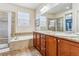 Elegant bathroom featuring a soaking tub, separate shower, double sinks, and modern finishes, creating a tranquil retreat at 6284 Orion Ct # B, Arvada, CO 80403