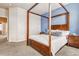 Bright bedroom featuring a wooden canopy bed, plush carpeting, and modern furnishings, providing a peaceful sanctuary at 6284 Orion Ct # B, Arvada, CO 80403