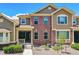 Two-story townhome featuring brick and siding exterior with well-maintained landscaping at 6284 Orion Ct # B, Arvada, CO 80403