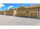 Row of tan garages on an asphalt parking area, offering ample parking and storage at 6284 Orion Ct # B, Arvada, CO 80403
