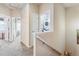 Hallway with staircase featuring stacked washer and dryer in adjacent closet at 6284 Orion Ct # B, Arvada, CO 80403