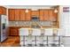 Stylish kitchen featuring wood cabinets, granite countertops, and stainless steel appliances at 6284 Orion Ct # B, Arvada, CO 80403
