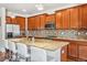 Spacious kitchen with stainless steel appliances, granite countertops, mosaic backsplash, and island with bar seating at 6284 Orion Ct # B, Arvada, CO 80403