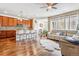 Open-concept living space featuring hardwood floors, a modern kitchen, and a comfortable sofa at 6284 Orion Ct # B, Arvada, CO 80403