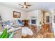 Bright living room with fireplace, hardwood floors, and a comfortable sectional sofa at 6284 Orion Ct # B, Arvada, CO 80403
