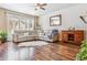 Spacious living room features hardwood floors, natural light, and a comfortable sectional sofa at 6284 Orion Ct # B, Arvada, CO 80403