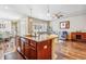 Open concept living room featuring hardwood floors, a neutral color palette, with views to the kitchen and dining room at 6284 Orion Ct # B, Arvada, CO 80403