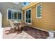 Back patio with tiled floor, string lights, and outdoor seating provides a relaxing retreat at 6284 Orion Ct # B, Arvada, CO 80403
