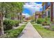 Quiet street featuring townhomes with manicured lawns and mature trees at 6284 Orion Ct # B, Arvada, CO 80403