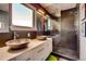Modern bathroom featuring dual vessel sinks, sleek vanity, and a glass-enclosed shower with dark tile at 4661 14Th St, Boulder, CO 80304