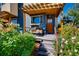 Inviting front porch with seating area, wood pergola, and mature landscaping offering a welcoming entry at 4661 14Th St, Boulder, CO 80304