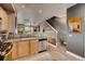 Kitchen with stainless steel dishwasher, a sink, open concept view of living area, and stairs nearby at 4661 14Th St, Boulder, CO 80304