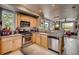 Well-lit kitchen with modern stainless steel appliances, wood cabinetry, and an open layout to dining at 4661 14Th St, Boulder, CO 80304
