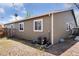 The side of the home shows low maintenance landscaping and a partial fence at 15427 E Oberlin Pl, Aurora, CO 80013