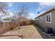 Image of the side yard featuring low maintenance landscaping, a fence, and some trees at 15427 E Oberlin Pl, Aurora, CO 80013