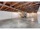 Unfinished basement with exposed wood beams and ductwork, concrete floor, and white walls at 15427 E Oberlin Pl, Aurora, CO 80013
