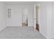 Clean bedroom with view to bath, featuring neutral tones and natural light at 15427 E Oberlin Pl, Aurora, CO 80013