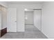 Bedroom featuring a large mirrored closet, neutral carpet, and bright white walls at 15427 E Oberlin Pl, Aurora, CO 80013