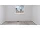 Bright bedroom featuring neutral carpet, white walls, and a window providing natural light at 15427 E Oberlin Pl, Aurora, CO 80013