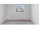 Bright bedroom featuring neutral carpet, white walls, and a window providing natural light at 15427 E Oberlin Pl, Aurora, CO 80013