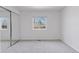 Bright bedroom with mirrored closet doors and neutral carpet at 15427 E Oberlin Pl, Aurora, CO 80013