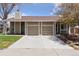 Charming home featuring a two-car garage and a well-maintained lawn and a clean concrete driveway at 15427 E Oberlin Pl, Aurora, CO 80013