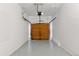 Spacious two-car garage with overhead door and neutral epoxy flooring at 15427 E Oberlin Pl, Aurora, CO 80013