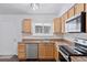 Well-lit kitchen with stainless steel appliances and a functional layout at 15427 E Oberlin Pl, Aurora, CO 80013