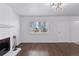 The living room has wood floors, a white brick fireplace, and modern lighting at 15427 E Oberlin Pl, Aurora, CO 80013