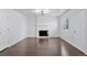 An open living space features a fireplace, hardwood floors, and neutral walls, offering a blank canvas at 15427 E Oberlin Pl, Aurora, CO 80013