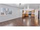 Spacious living room with hardwood floors and stainless steel appliances in the kitchen area at 15427 E Oberlin Pl, Aurora, CO 80013