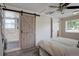 Bedroom with a barn door access to a bathroom with glass-enclosed shower at 2812 Krameria St, Denver, CO 80207