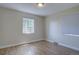 Simple bedroom with hardwood floors and a view from the windows to the outside at 2812 Krameria St, Denver, CO 80207