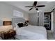 Bedroom with neutral colors, a ceiling fan, and a barn door at 2812 Krameria St, Denver, CO 80207