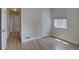 Neutral bedroom featuring hardwood floors, white trim and window with shade at 2812 Krameria St, Denver, CO 80207