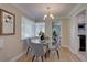 Cozy dining room with a glass table, chandelier, and natural light from the corner windows at 2812 Krameria St, Denver, CO 80207
