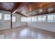 Bright sunroom with wood paneled ceiling, hardwood floors and plentiful windows at 2812 Krameria St, Denver, CO 80207