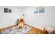 Cozy bedroom with hardwood floors, a stylish rug, and plenty of natural light at 7841 Oneida St, Commerce City, CO 80022