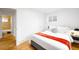 Comfortable bedroom with a cozy bed, hardwood floors, and ample natural light at 7841 Oneida St, Commerce City, CO 80022