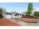 Inviting single-story home with a lush landscaped front yard and a driveway leading to the attached garage at 7841 Oneida St, Commerce City, CO 80022