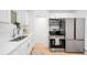 Modern kitchen featuring stainless steel appliances, sleek white cabinets, and ample counter space at 7841 Oneida St, Commerce City, CO 80022