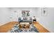 Cozy living room featuring hardwood floors, a comfortable sofa, and plenty of natural light at 7841 Oneida St, Commerce City, CO 80022